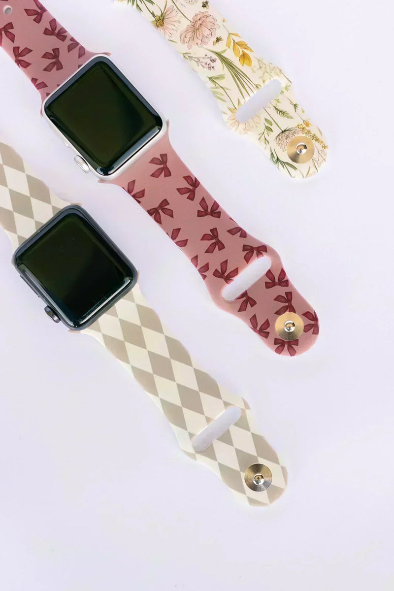 Flat lay of patterned Apple Watch silicone bands from Walli showing metal pin closures.
